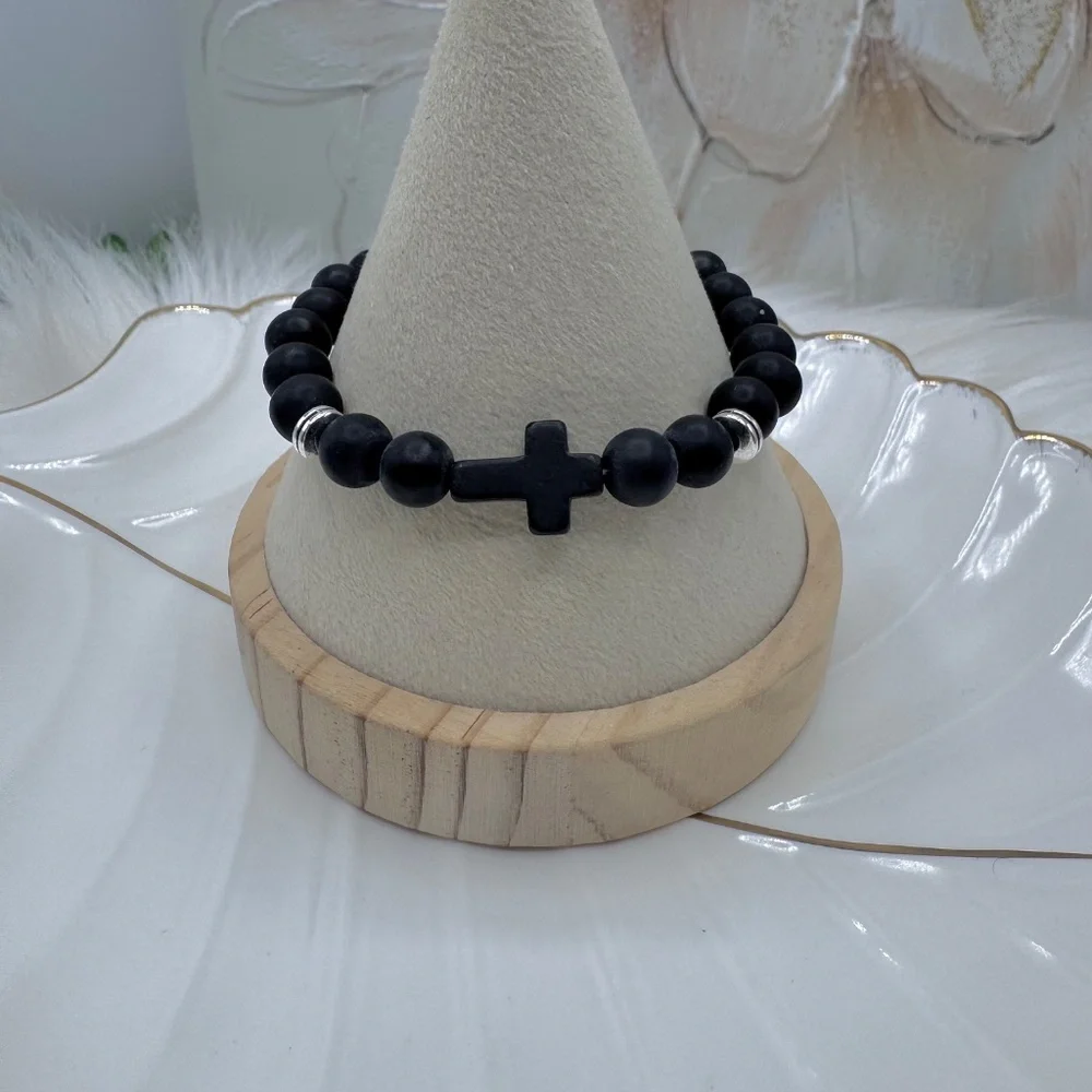 This elegant bracelet features smooth matte black beads paired with a bold black